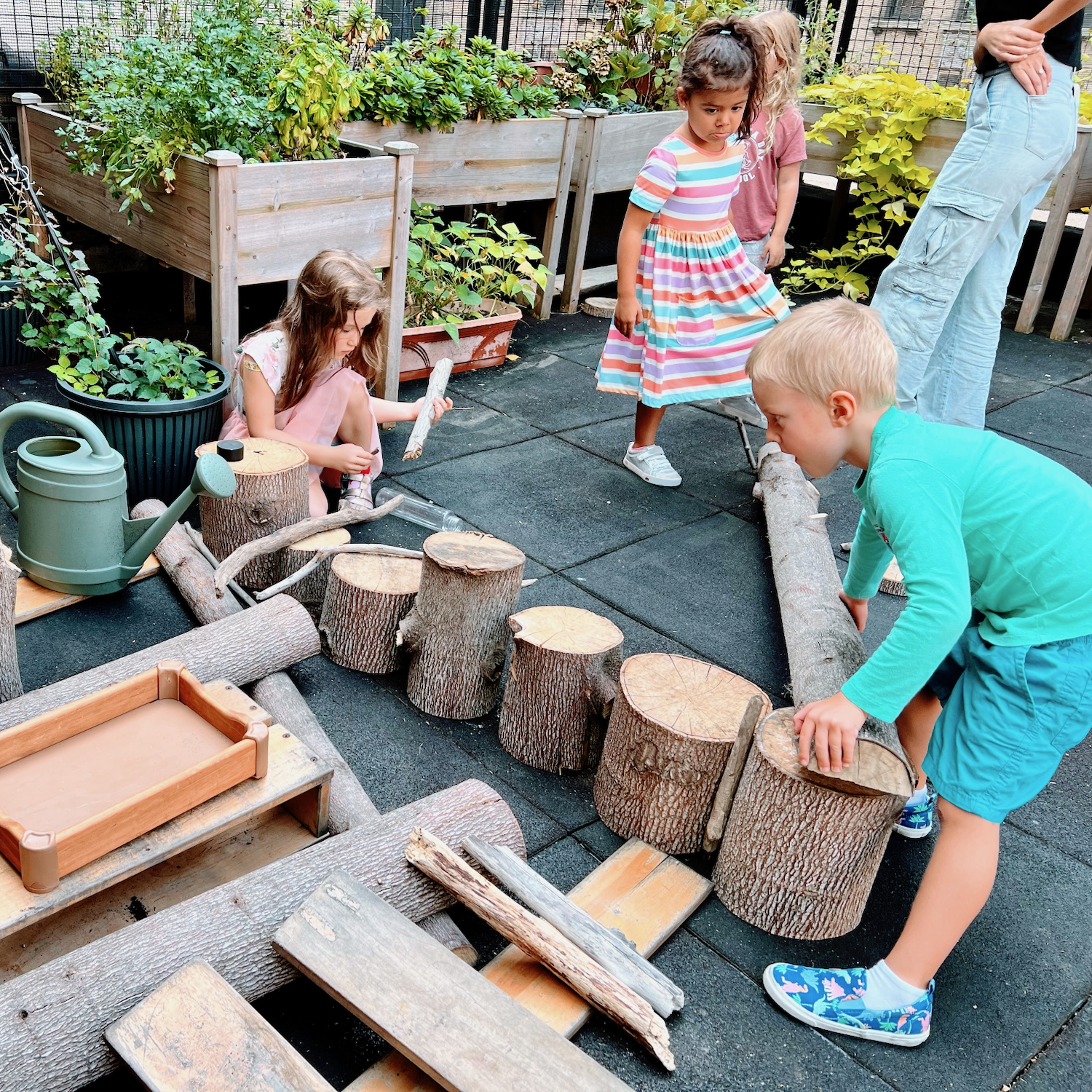 children playing outside on a rooftop with natural materials